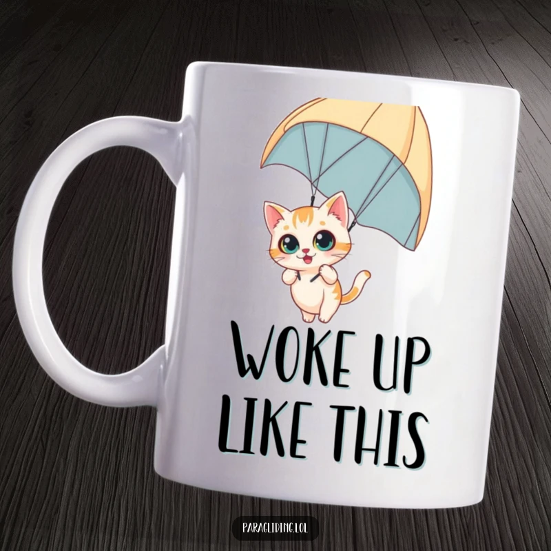 Funny mug with a curious cat dangling from a paraglider with wide eyes, showing daring adventure and feline fascination, a delightful funny gift.