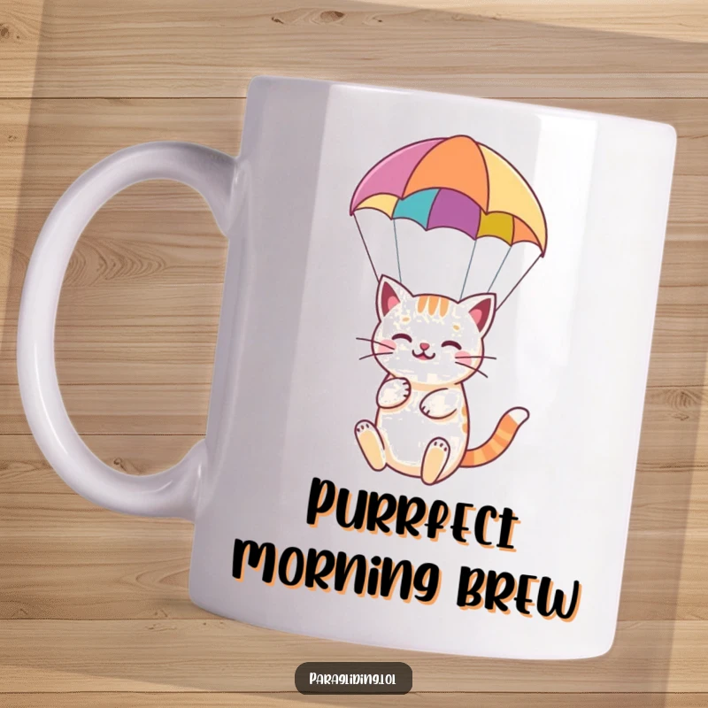 Funny mug featuring a happy cat serenely floating under a colorful paraglider, embodying peaceful aerial joy.