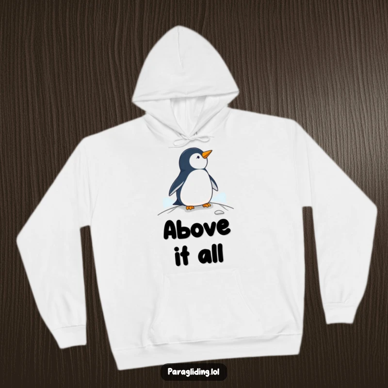 Funny penguin hoodie, a warm garment featuring a penguin observing from a paraglider, ideal for cozy relaxation.