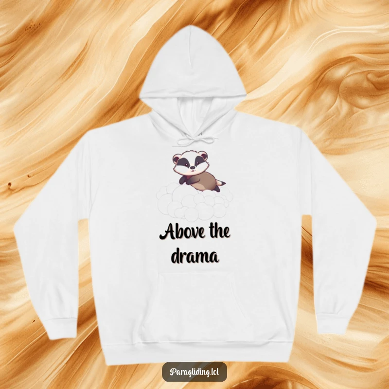 Funny hoodie illustrating a graceful badger gently gliding over a sea of fluffy clouds, exuding peace and a hint of playful charm.