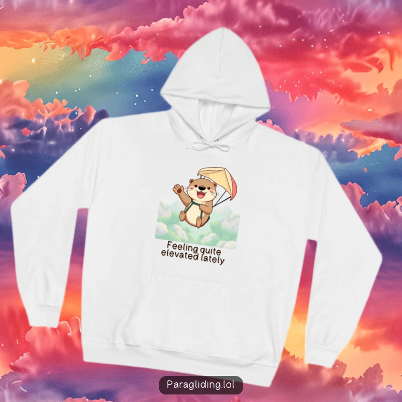 Funny hoodie with a happy otter gleefully waving while paragliding high in a vibrant sky, celebrating adventure and comfort.