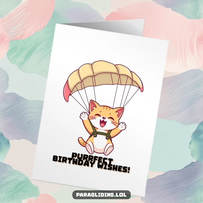 Funny Free Printable Birthday Card showing a giggling cat excitedly waving its paw from underneath a large, colorful paraglider canopy.