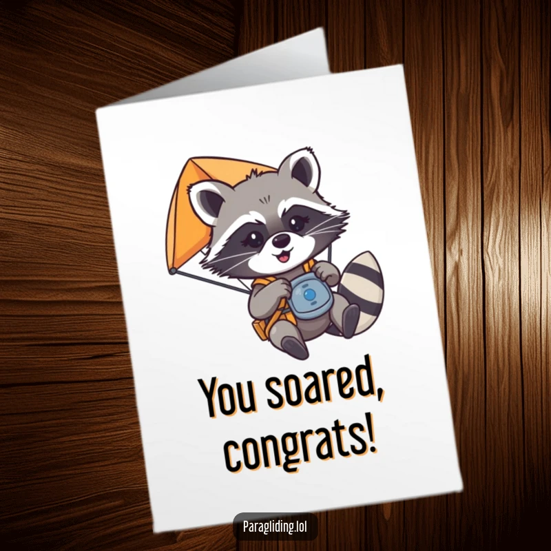 Funny Free Printable Congratulations Card: A mischievous raccoon playfully grabbing paraglider controls, celebrating a daring achievement.