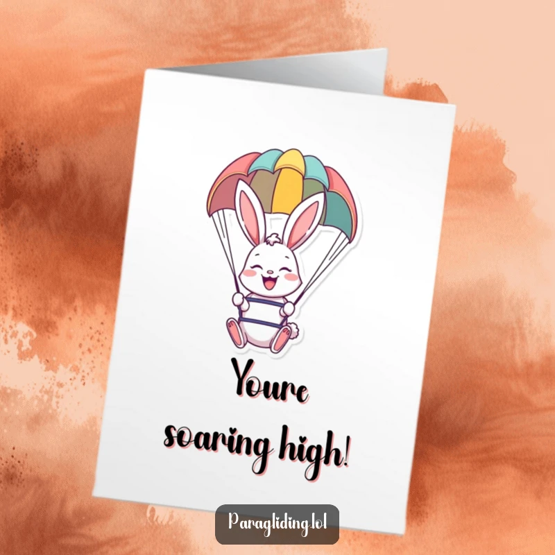 Funny Free Printable Congratulations Card of a cheerful bunny smiling widely, gently descending under a vibrant paraglider.