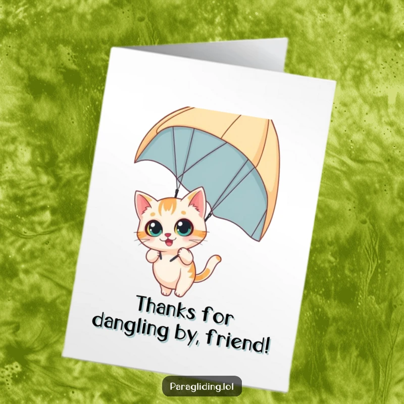 Funny Free Printable Thank You Card of a curious cat with wide-eyed wonder dangling from a paraglider, perfect for thanks.