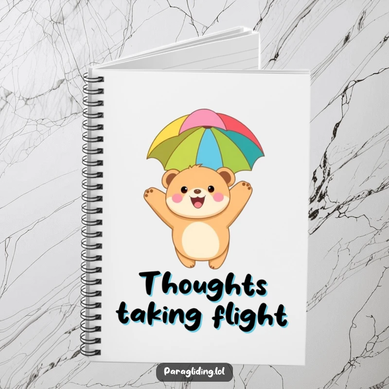 Funny notebook with a joyful, round bear cub paragliding under a colorful canopy, designed for jotting down ideas and dreaming big.