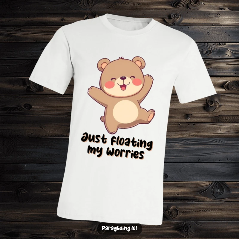 Funny playful bear bobs joyfully in the air, a happy paraglider spreading cheer on a comfortable t-shirt.