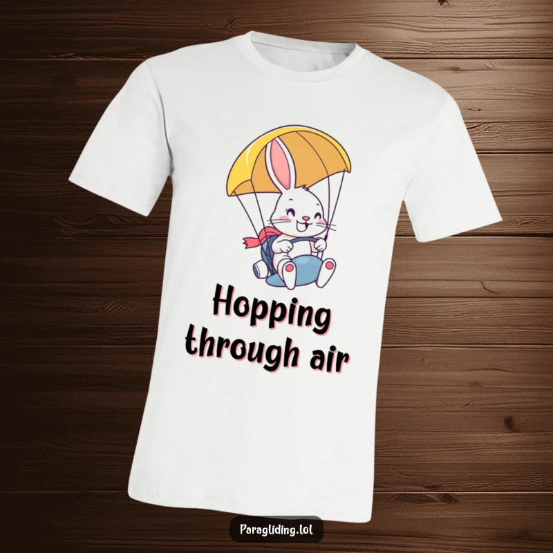 Funny t-shirt depicting a determined, smiling bunny confidently steering a paragliding with a wide grin, embodying pure bravery and adventure.
