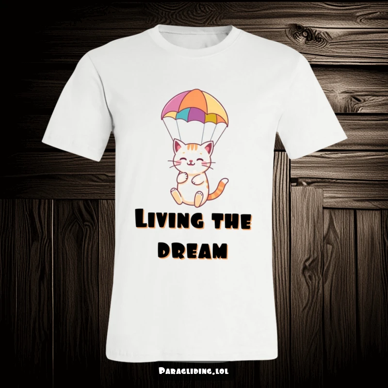 Funny t-shirt depicting a happy cat peacefully paragliding under a vibrant parachute, showcasing serene feline adventure.