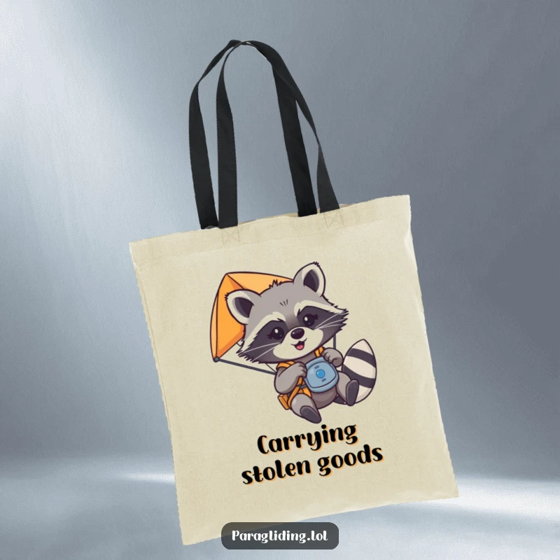 Funny mischievous raccoon playfully tugging on paraglider controls, on a tote bag, a great funny gift.